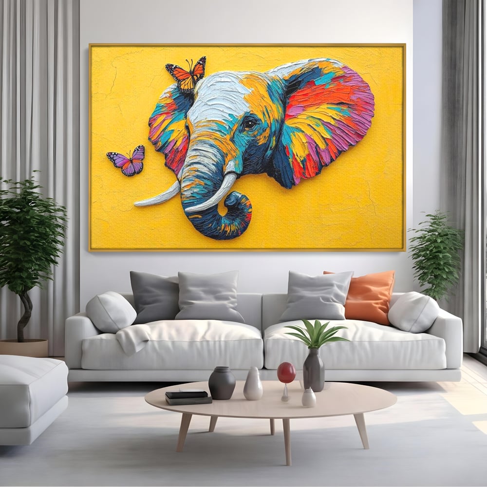 Tablou canvas cu tablou canvas cu elefant colorat si fluturi, in rama de aluminiu auriu, pe perete intr-un living